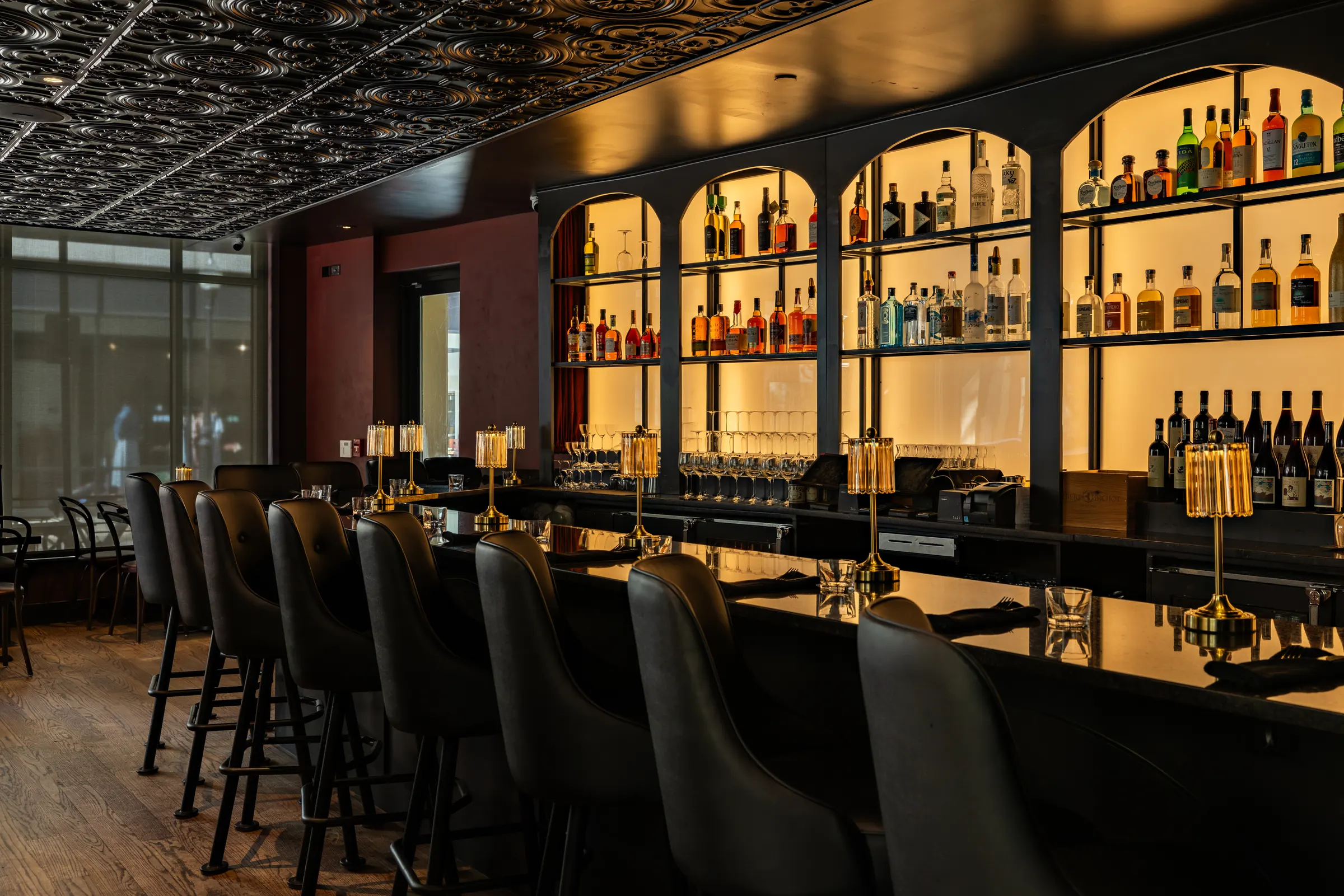 Bar Rosso bar with backlit arched liquor shelves