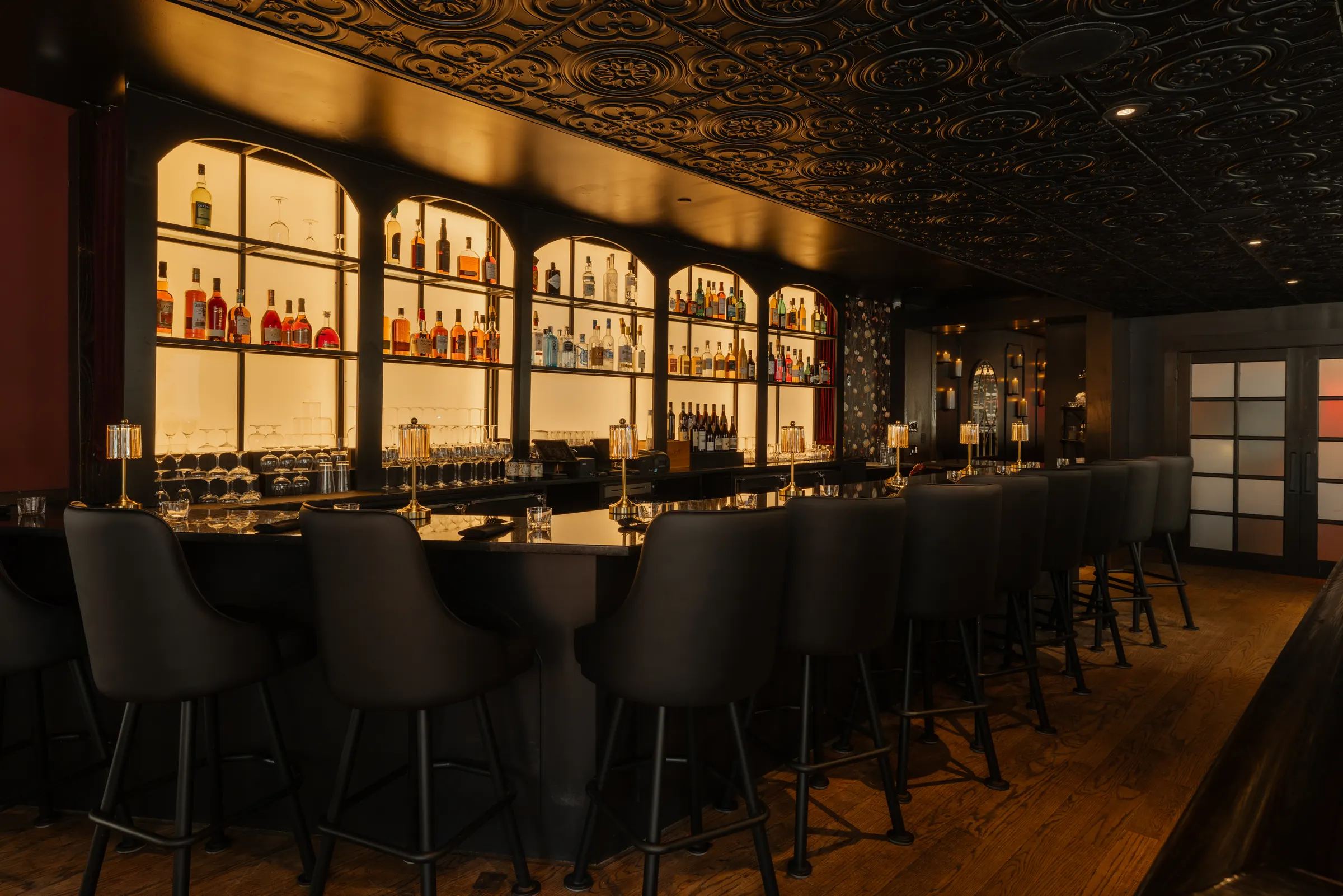 Bar counter and stools under the pressed tin ceiling