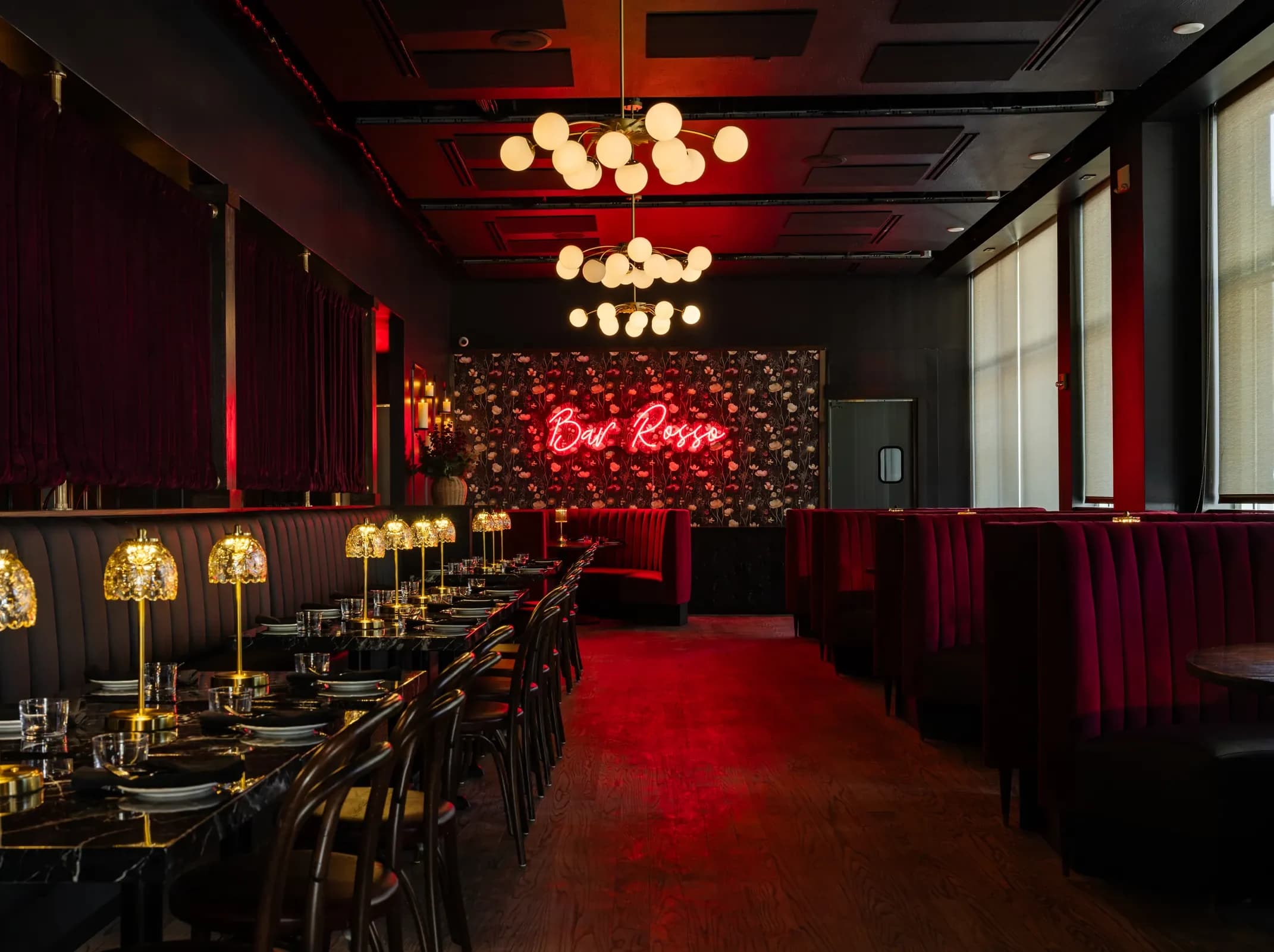 Bar Rosso dining room with the neon Bar Rosso sign, red velvet booths and brass table lamps in Over-the-Rhine, Cincinnati
