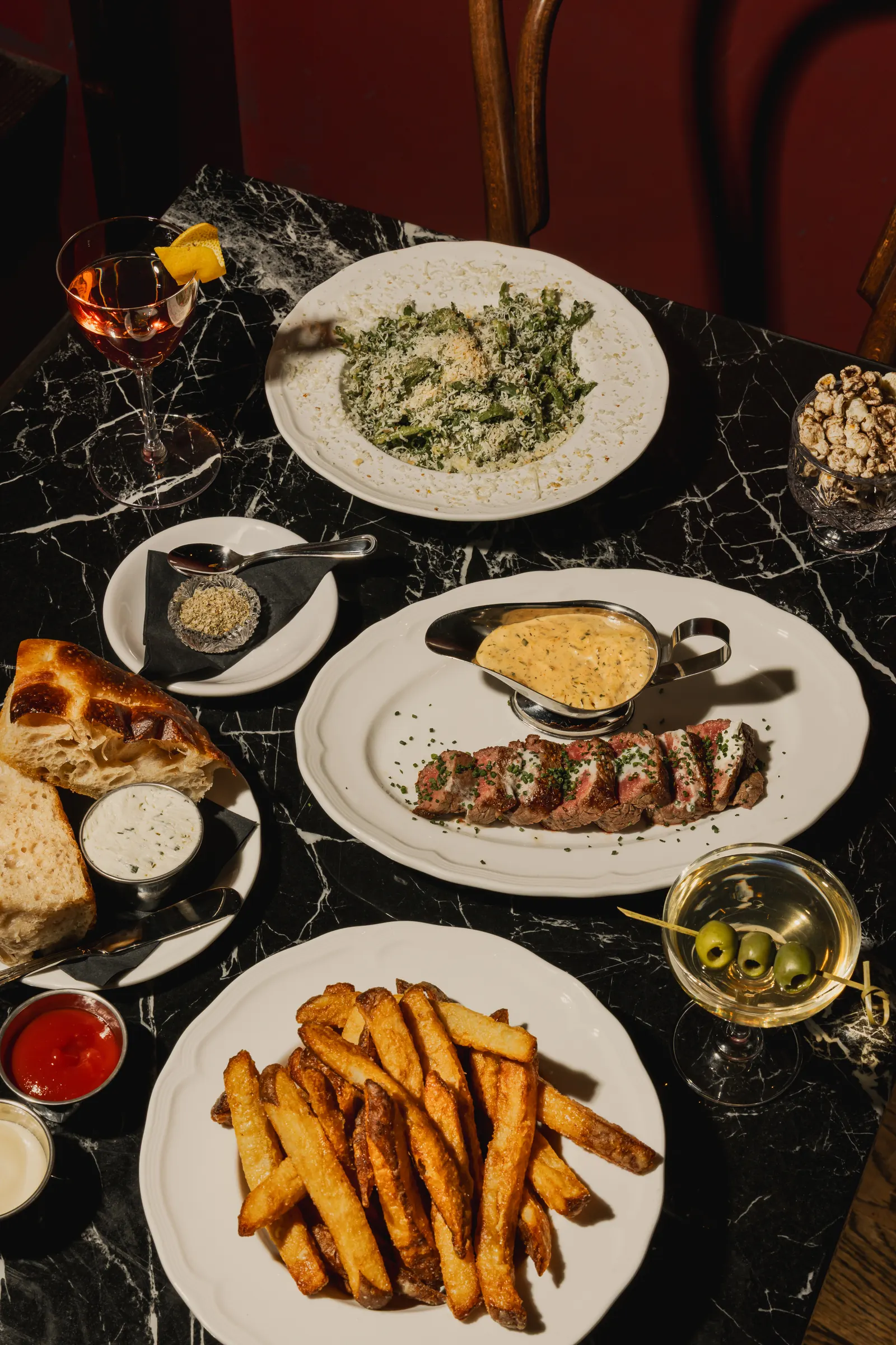 Overhead view of the Bar Rosso steak frites dinner spread